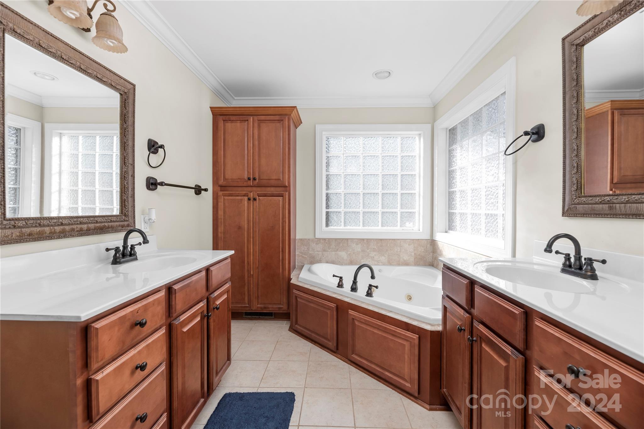 1350 Kensington Circle Newton, NC 28658 - Photo 14 of 45 a spacious bathroom with double vanity a mirror a bathtub and double