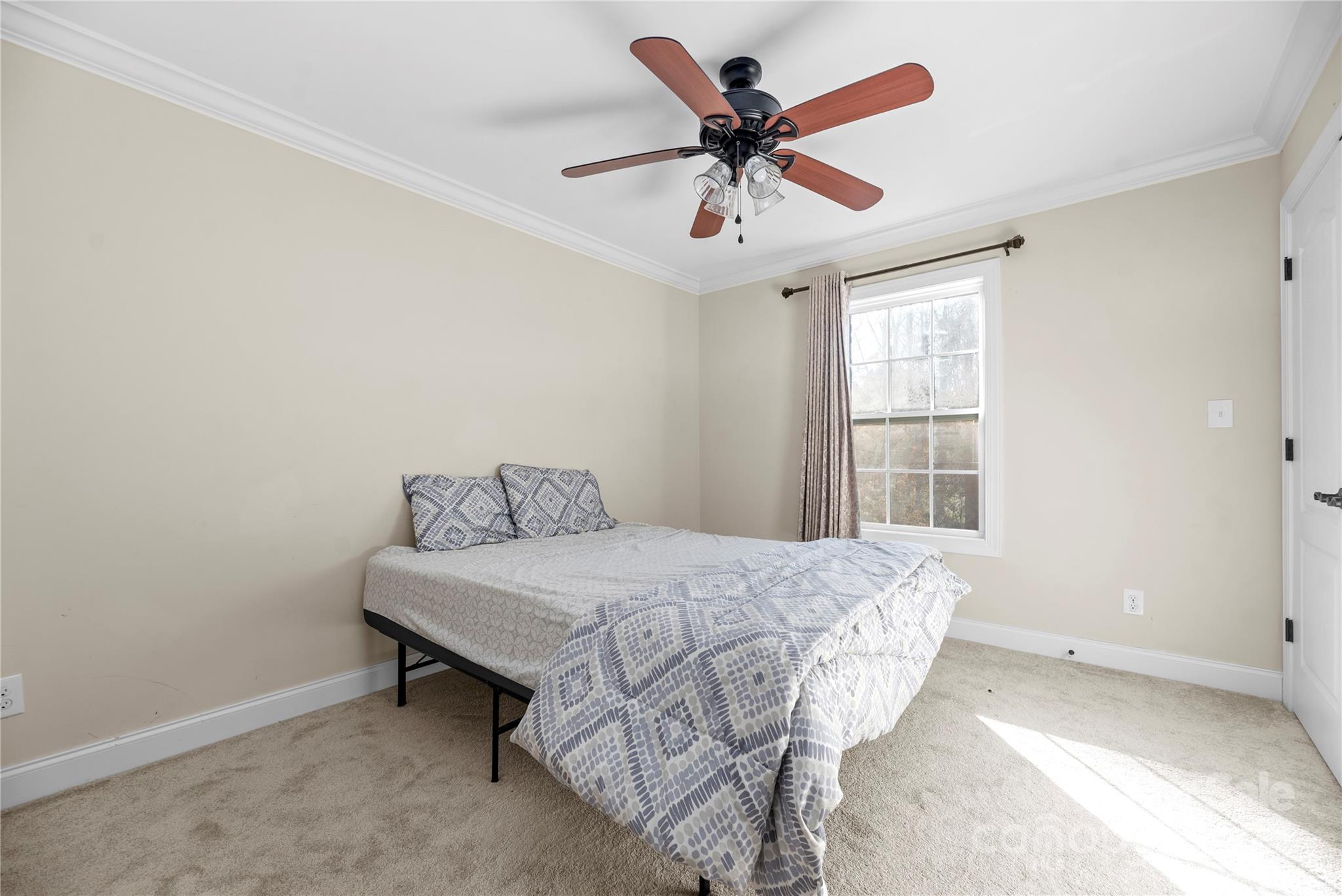 1350 Kensington Circle Newton, NC 28658 - Photo 19 of 45 a bed sitting in a bedroom next to a window