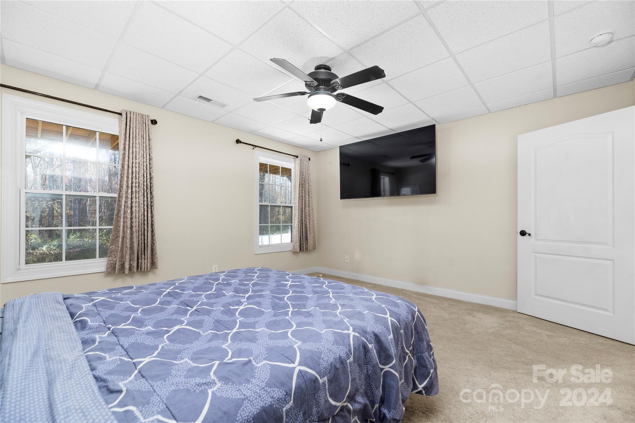 1350 Kensington Circle Newton, NC 28658 - Photo 31 of 45 a bedroom with a large bed and a flat tv screen