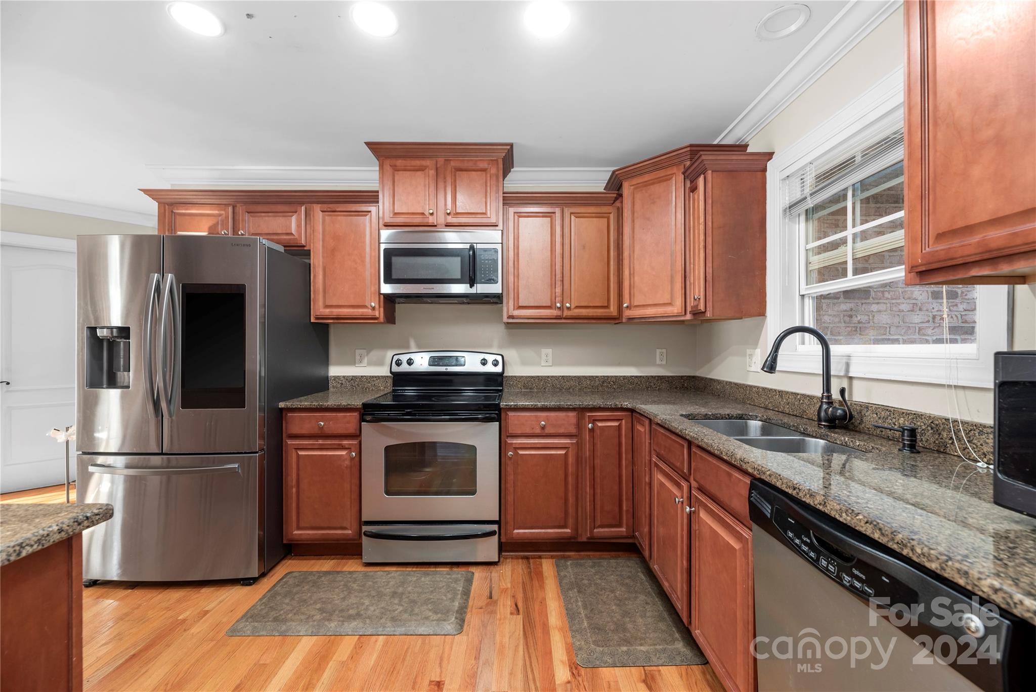 1350 Kensington Circle Newton, NC 28658 - Photo 6 of 45 a kitchen with stainless steel appliances granite countertop a sink stove microwave and refrigerator