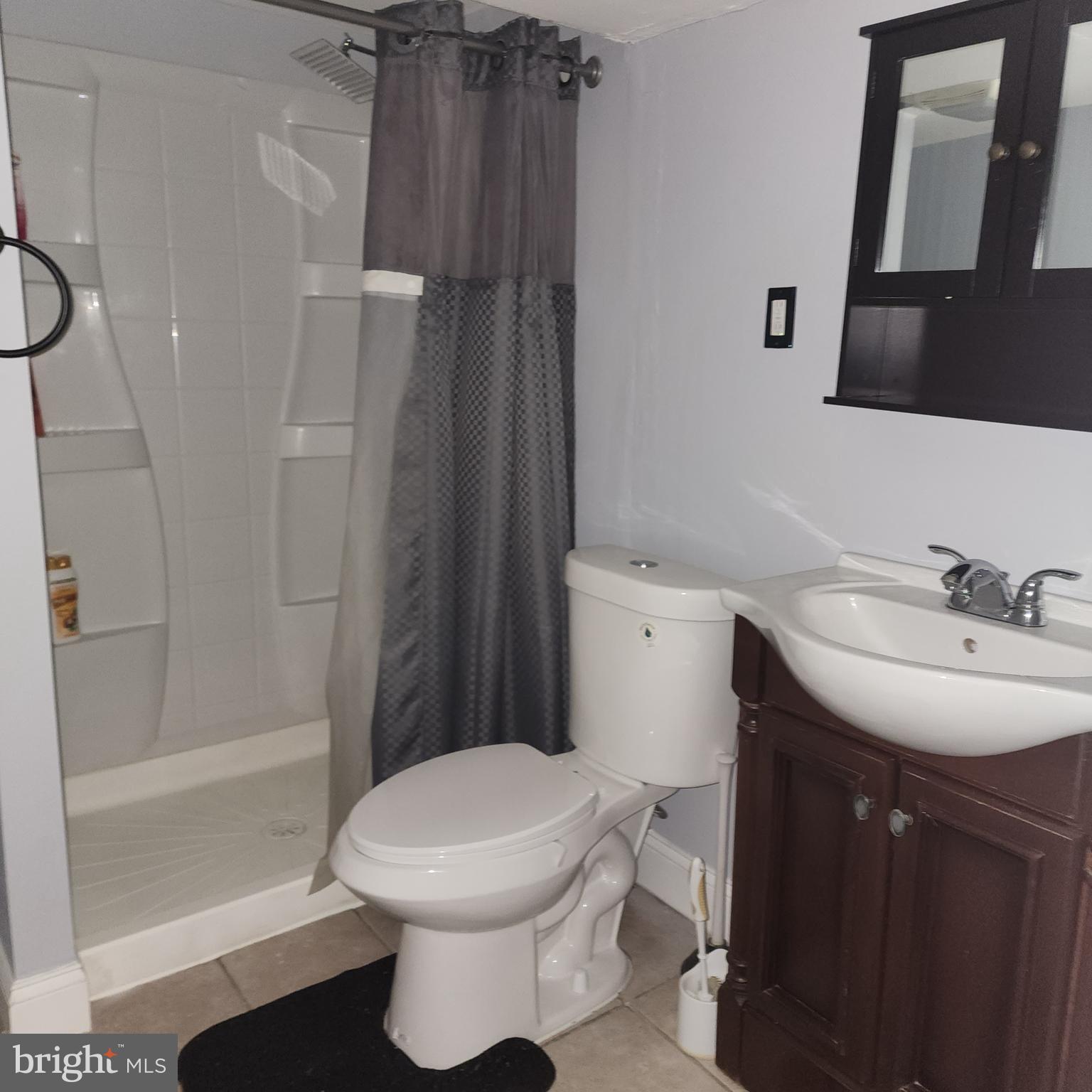 327 Grove Park Road Brooklyn, MD 21225 - Photo 14 of 20 a bathroom with a sink toilet and shower