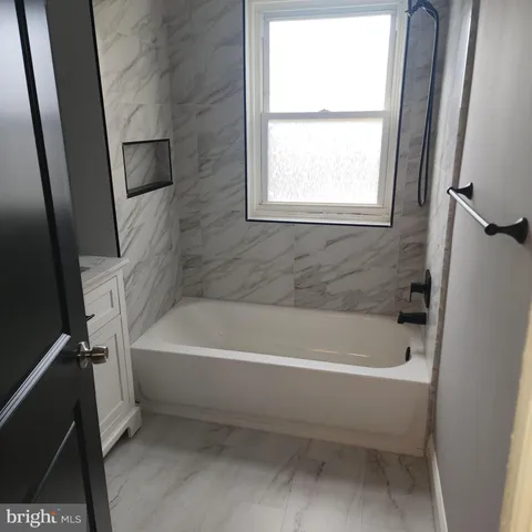 a white bath tub sitting next to a white sink