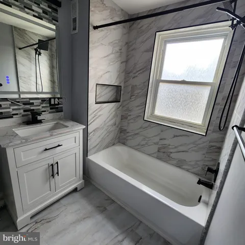 a bathroom with a bathtub and a sink