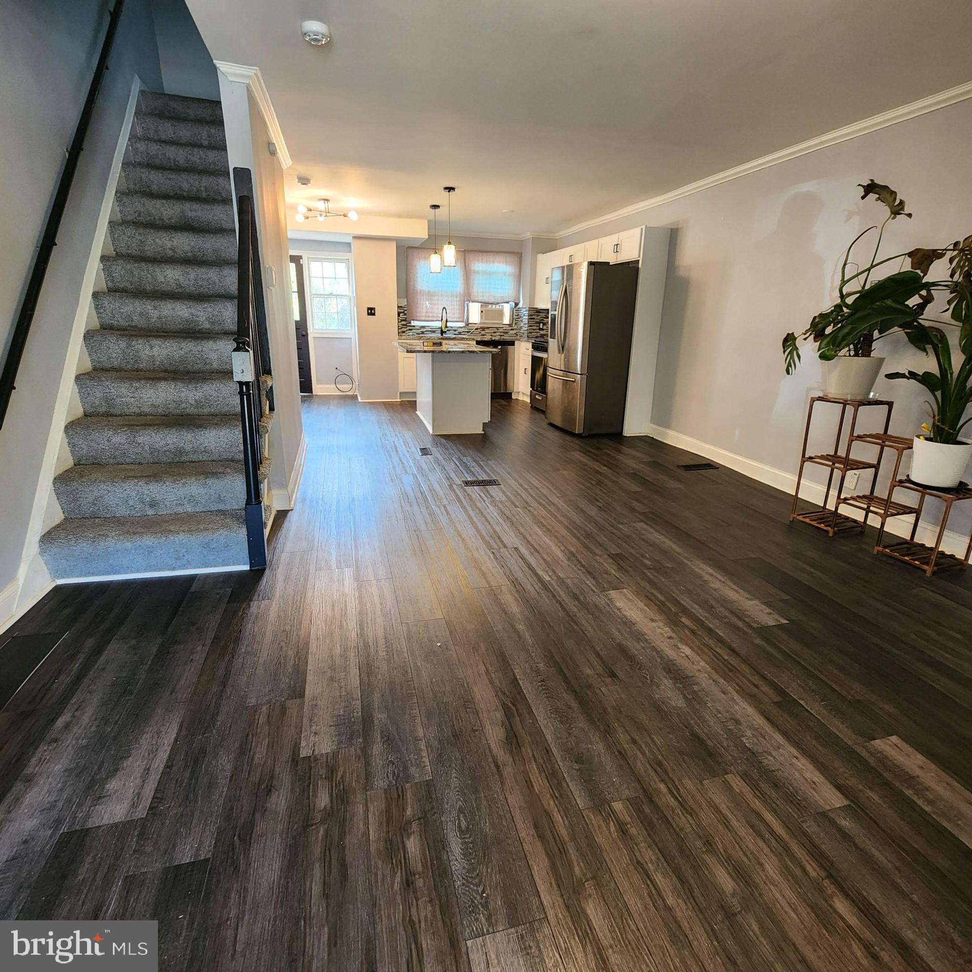 327 Grove Park Road Brooklyn, MD 21225 - Photo 2 of 20 a view of a living room with wooden floor and stairs