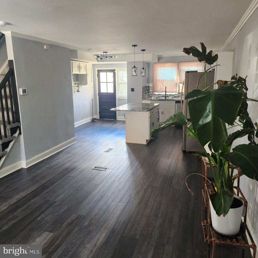 327 Grove Park Road Brooklyn, MD 21225 - Photo 4 of 20 a living room with furniture and a wooden floor