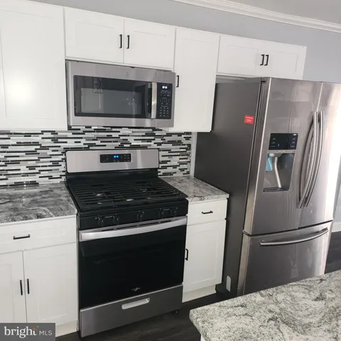 a kitchen with a stove microwave and refrigerator