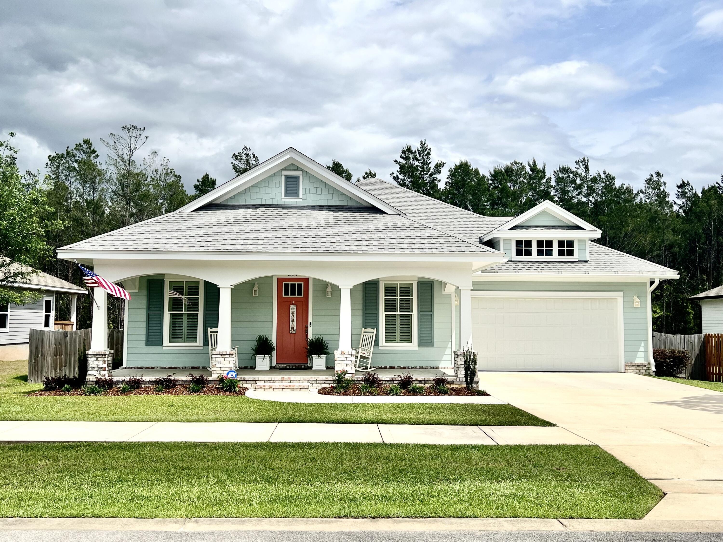 a front view of a house with a yard table and chairs