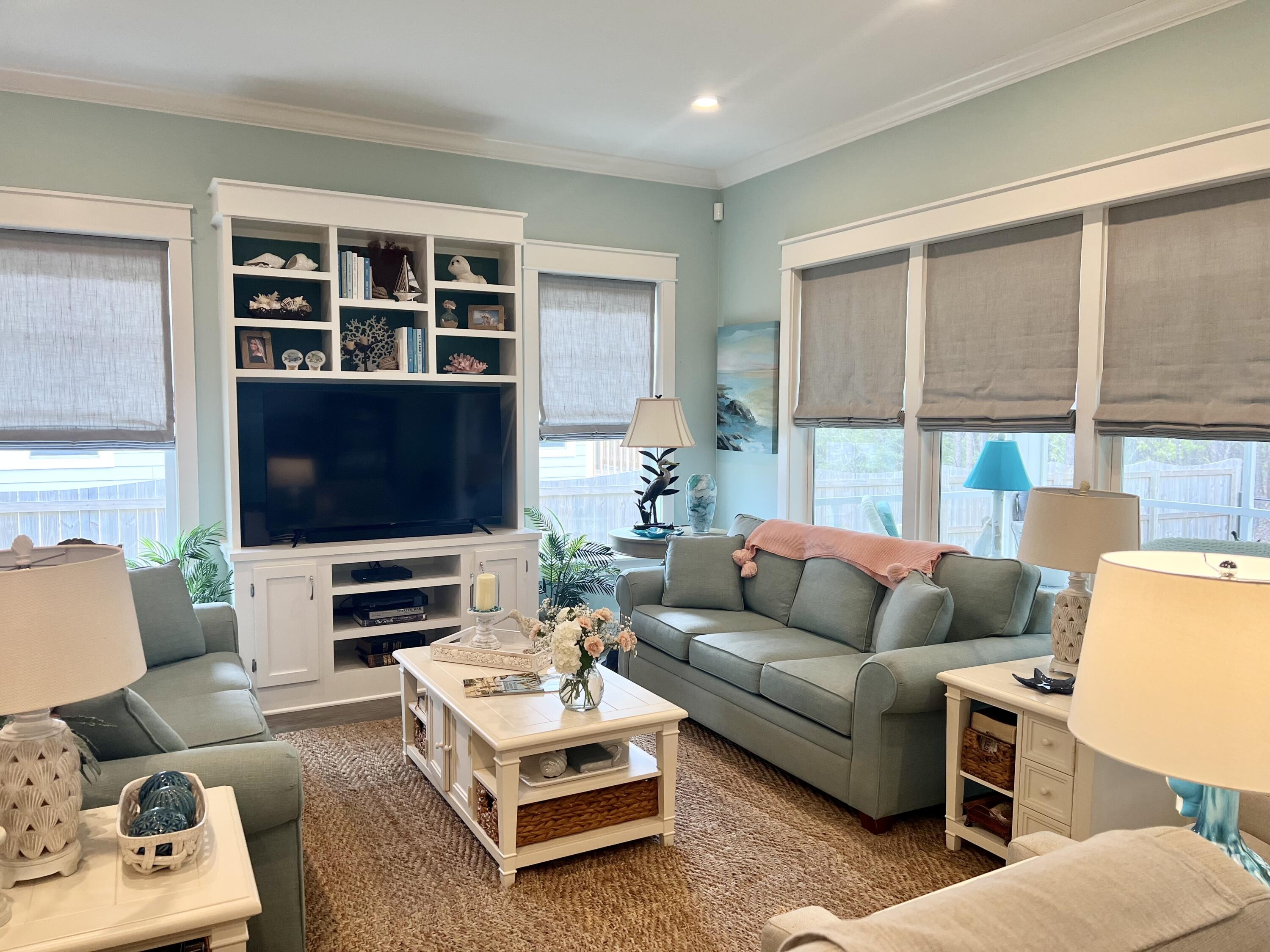 244 Perimeter Place Freeport, FL 32439 - Photo 23 of 72 a living room with furniture a flat screen tv and a large window