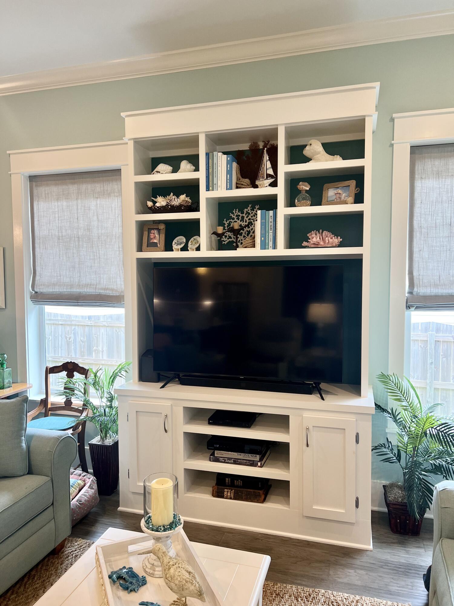 244 Perimeter Place Freeport, FL 32439 - Photo 25 of 72 a living room with a bookshelf a potted plant and a window