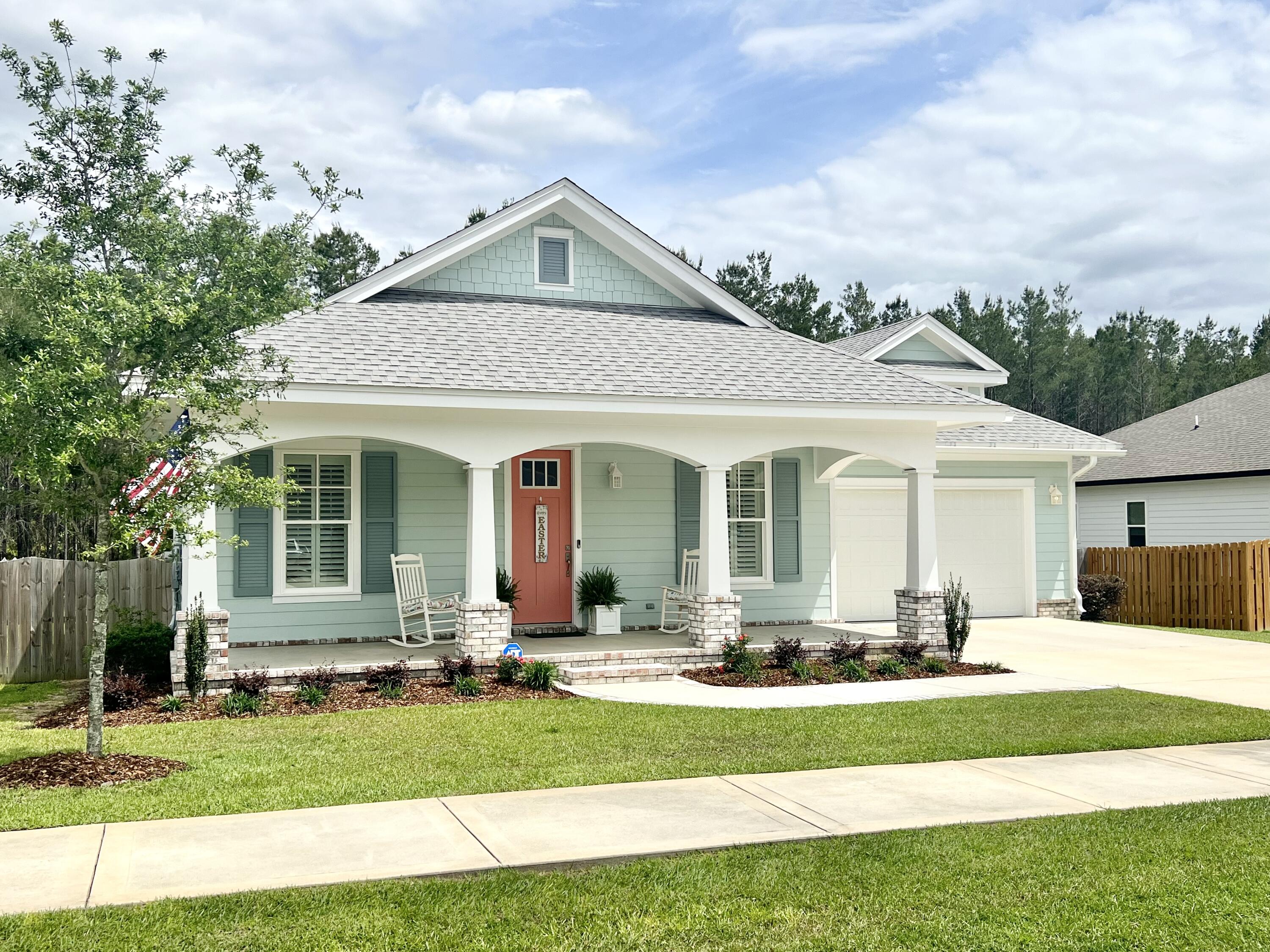 244 Perimeter Place Freeport, FL 32439 - Photo 3 of 72 a front view of a house with a yard