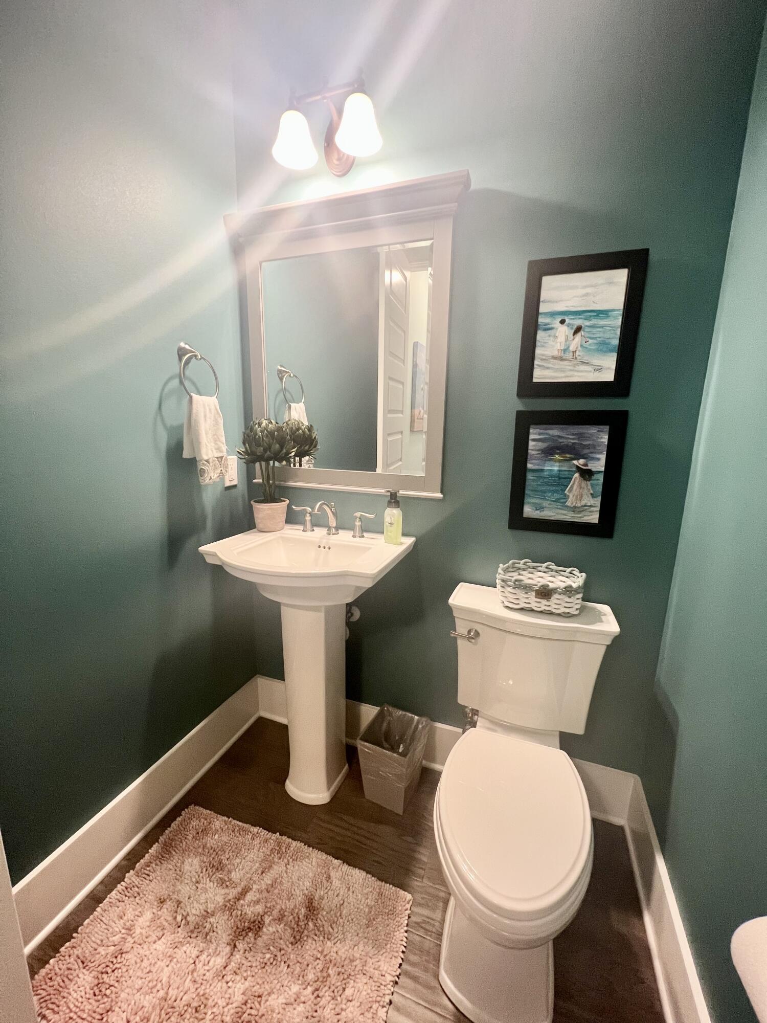 244 Perimeter Place Freeport, FL 32439 - Photo 42 of 72 a bathroom with a toilet sink and mirror