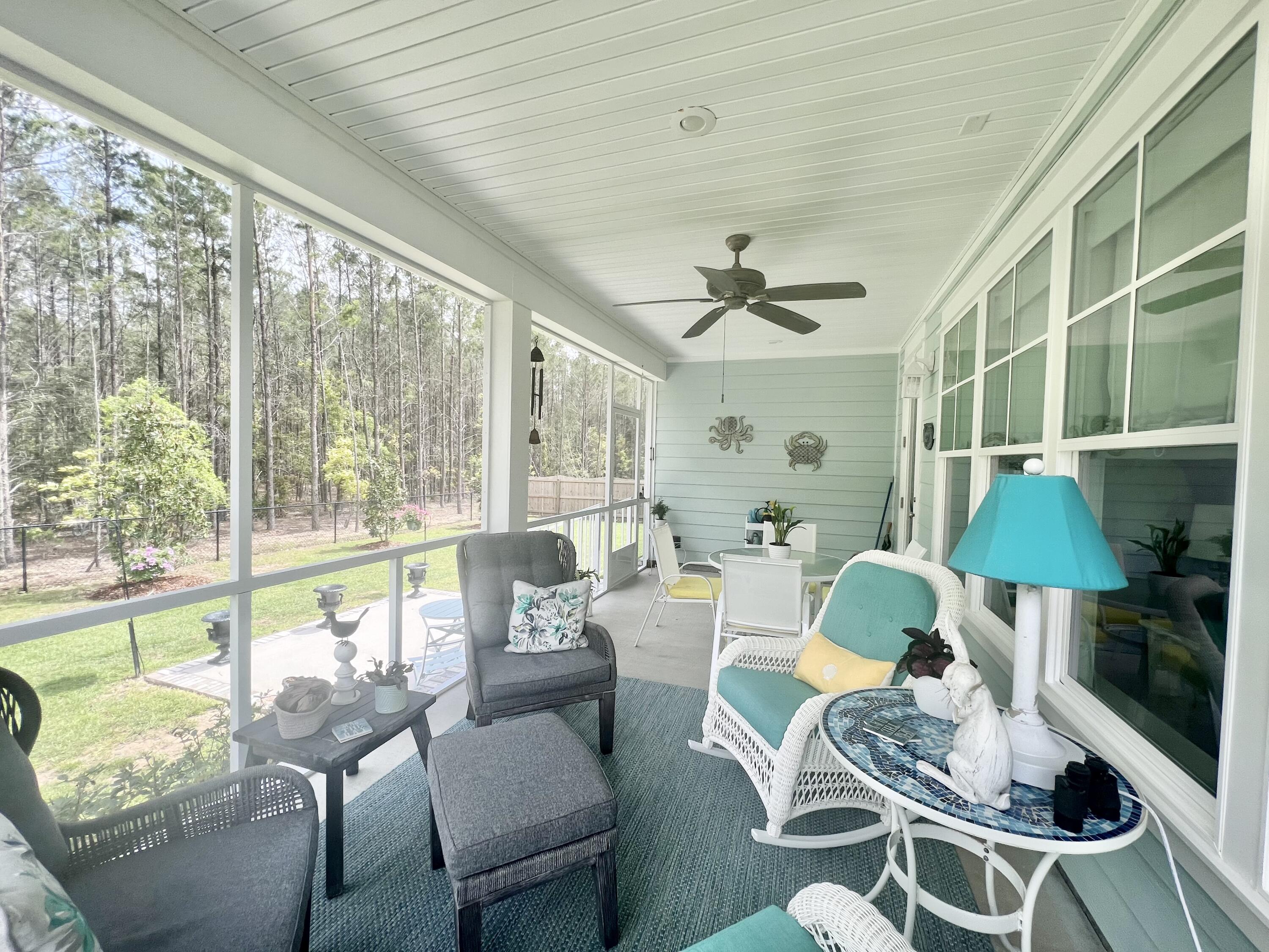 244 Perimeter Place Freeport, FL 32439 - Photo 61 of 72 a living room with furniture and a floor to ceiling window