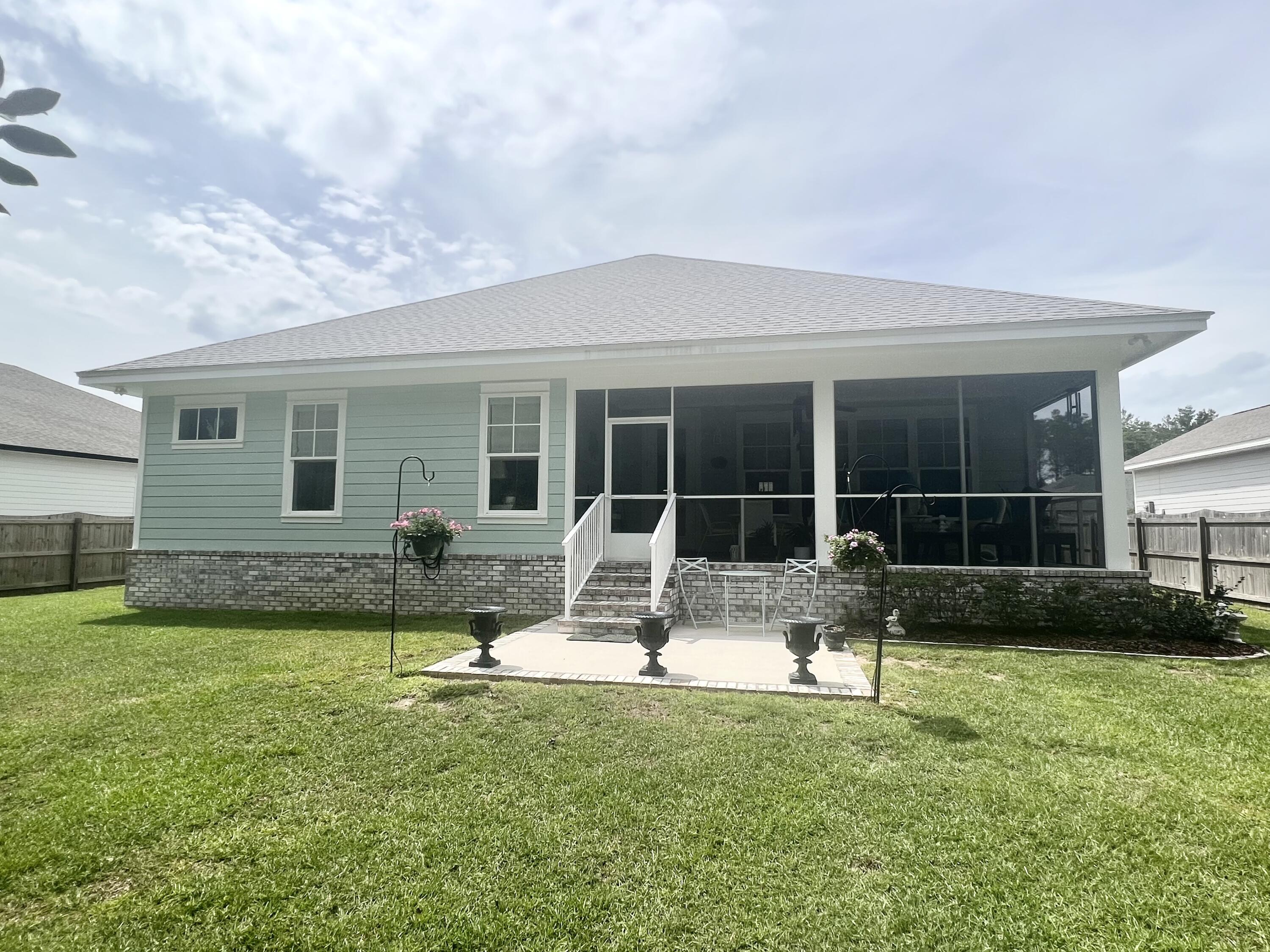 244 Perimeter Place Freeport, FL 32439 - Photo 64 of 72 a front view of house with yard and outdoor seating