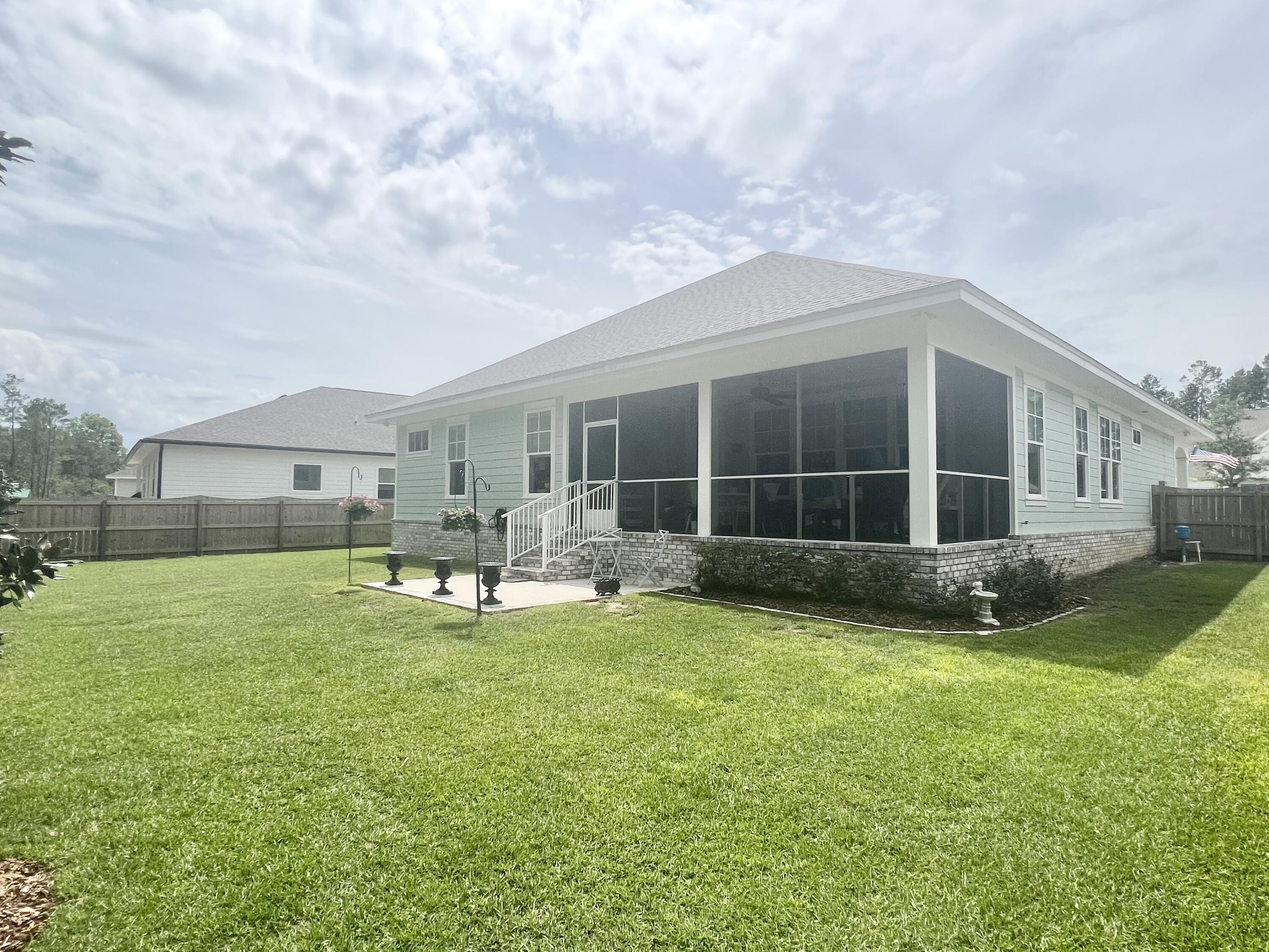 244 Perimeter Place Freeport, FL 32439 - Photo 65 of 72 a view of a house with a backyard and a sitting area