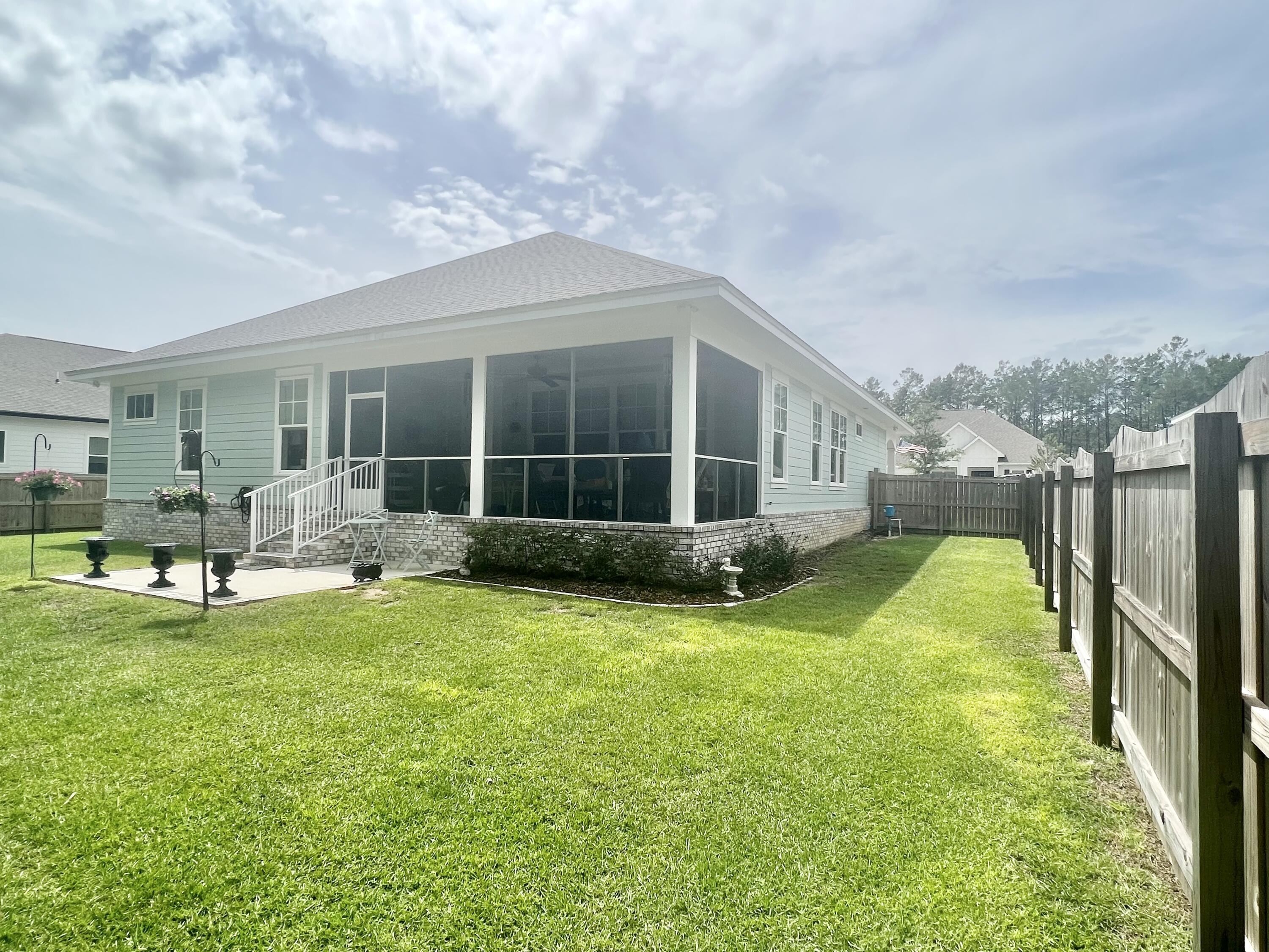244 Perimeter Place Freeport, FL 32439 - Photo 66 of 72 a view of a house with backyard and sitting area