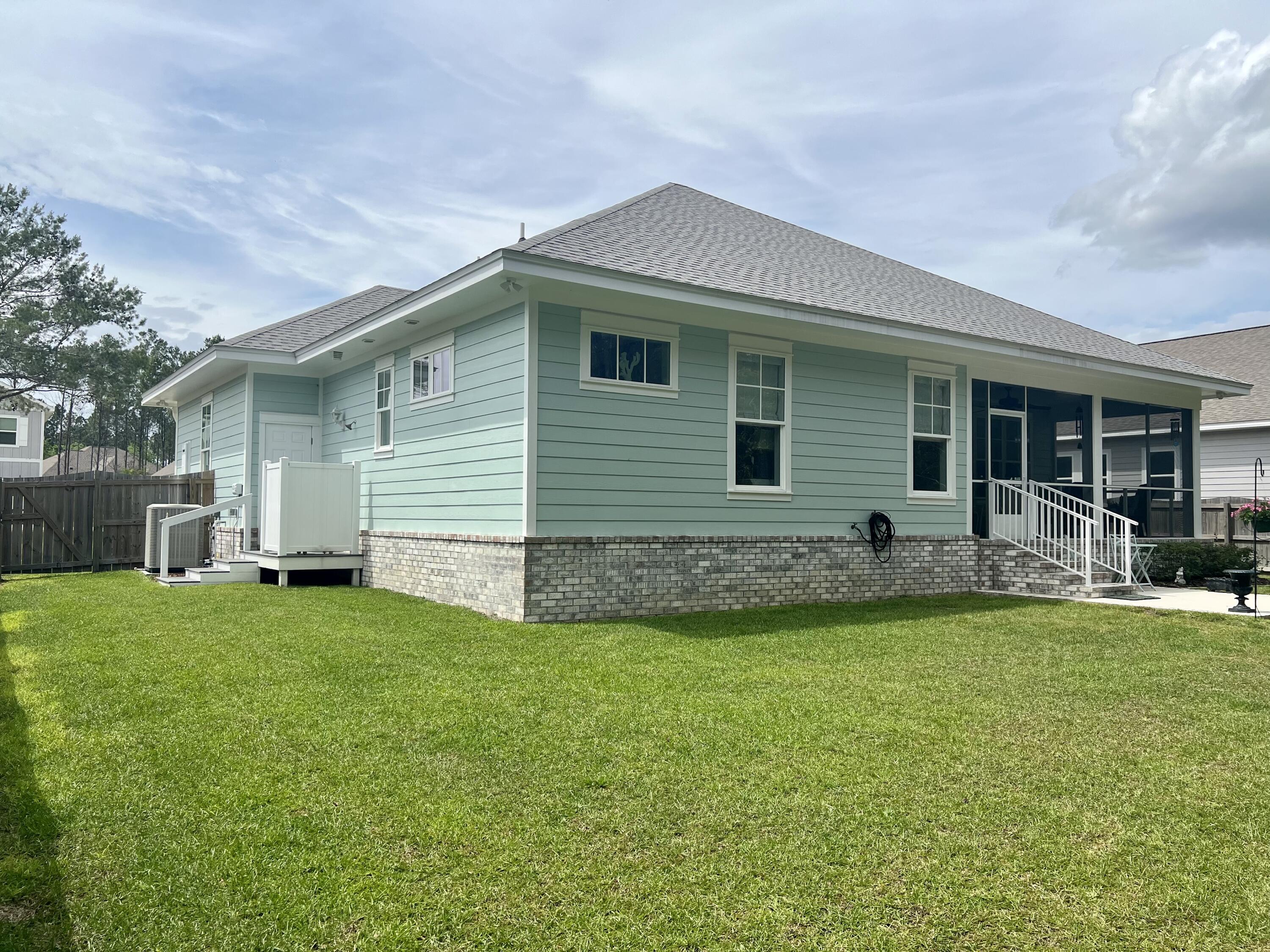 244 Perimeter Place Freeport, FL 32439 - Photo 69 of 72 a front view of house with yard and outdoor seating