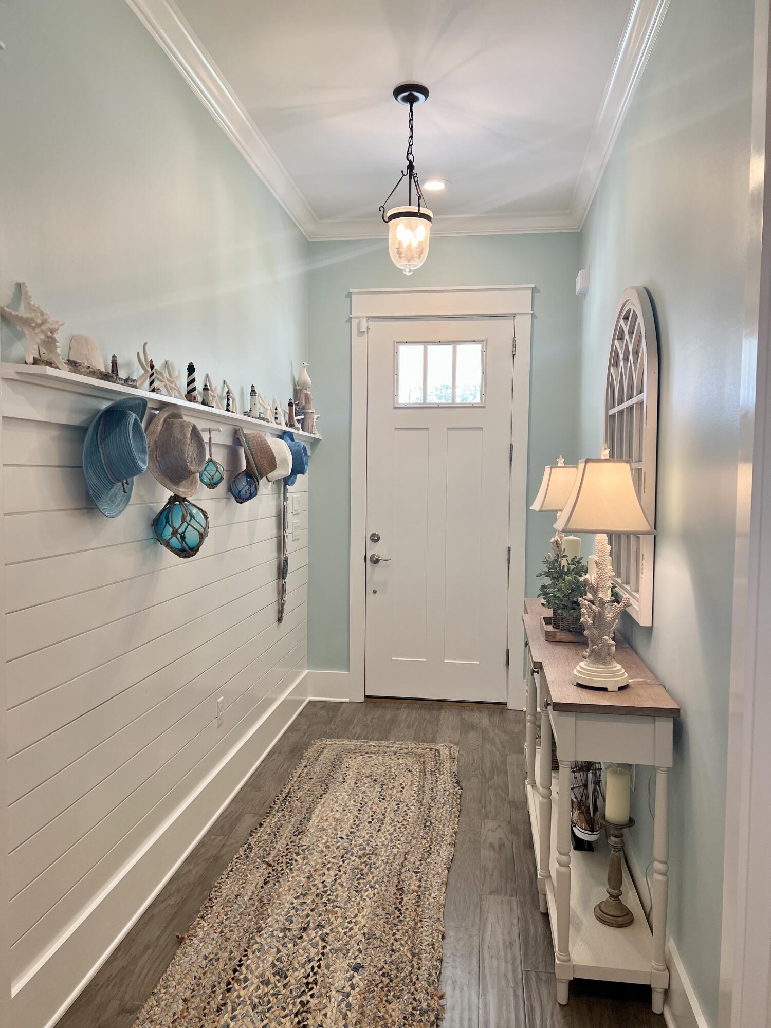 244 Perimeter Place Freeport, FL 32439 - Photo 8 of 72 a view of a hallway with entryway wooden floor and front door
