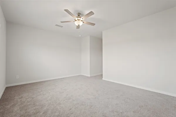an empty room with a chandelier fan