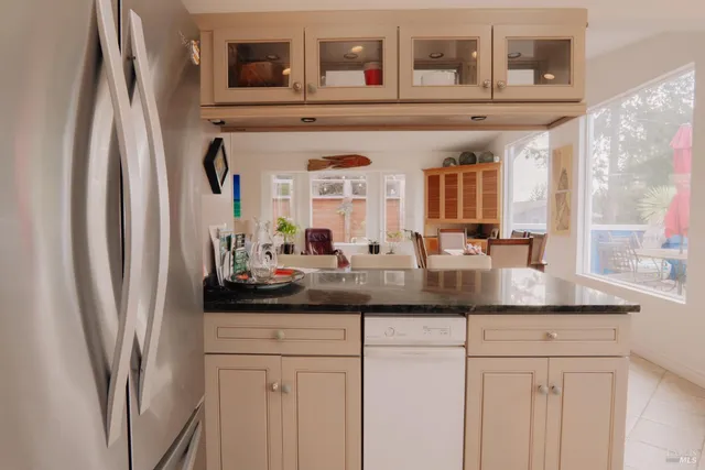 a kitchen with a sink cabinets and a window