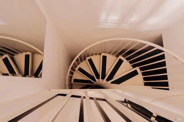 a large bed in a white room