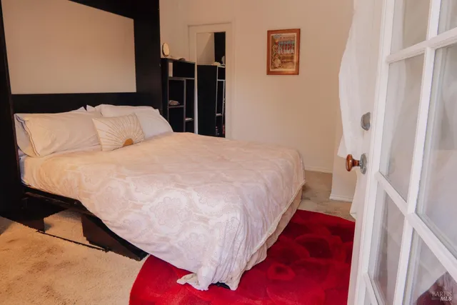 a bed sitting in a bedroom next to a window