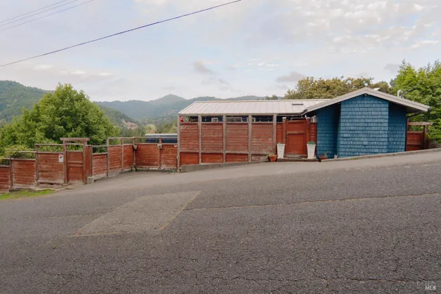 a view of a patio with chairs and plants