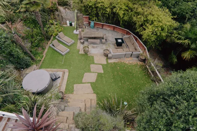 an aerial view of a house with a yard and garden