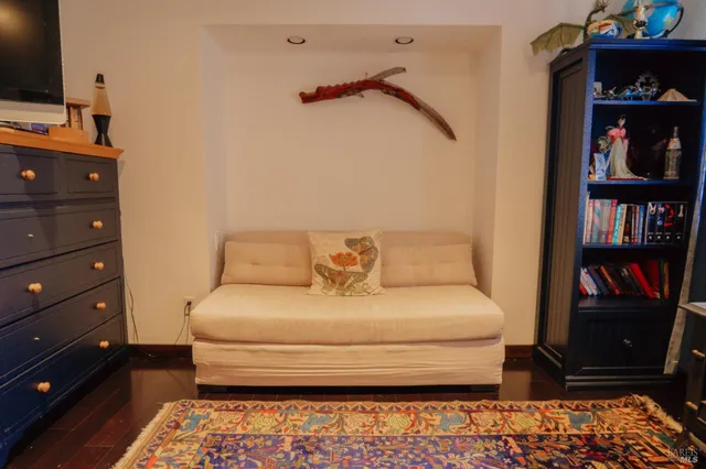 a bedroom with a bed and a bookshelf