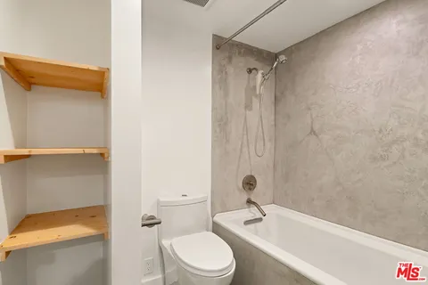 a bathroom with a toilet a sink and bathtub