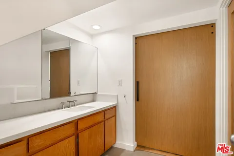 a bathroom with a double vanity sink and a mirror