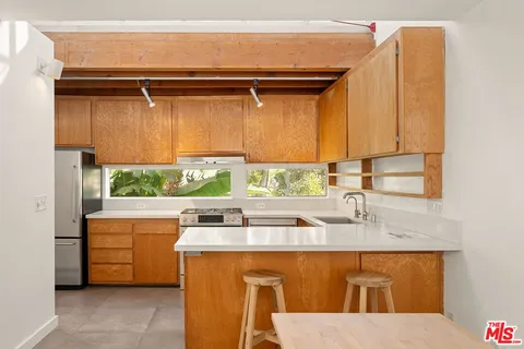 a kitchen with a sink and a refrigerator