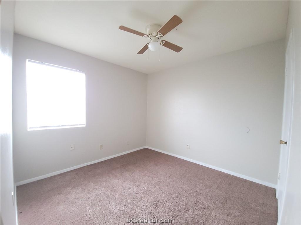2712 Evergreen Circle Bryan, TX 77801 - Photo 12 of 30 Spare room with carpet floors and ceiling fan
