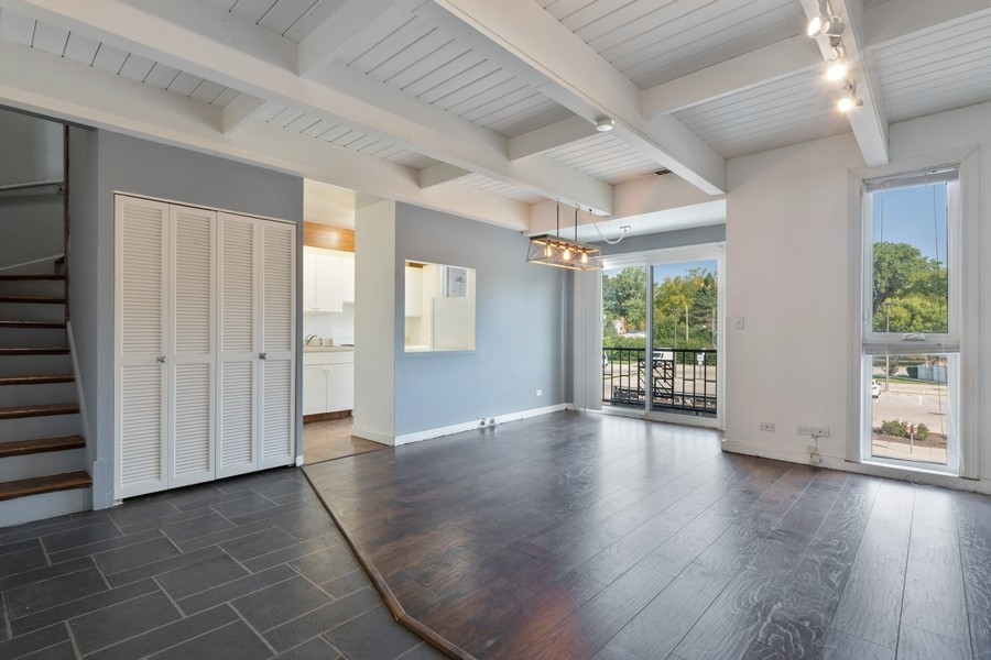 2114 Central Street, Unit A Evanston, IL 60201 - Photo 2 of 10 an empty room with wooden floor and windows