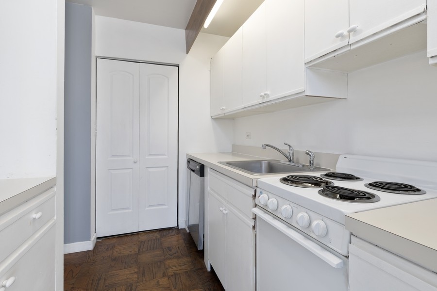 2114 Central Street, Unit A Evanston, IL 60201 - Photo 5 of 10 a kitchen with a stove and a white cabinets