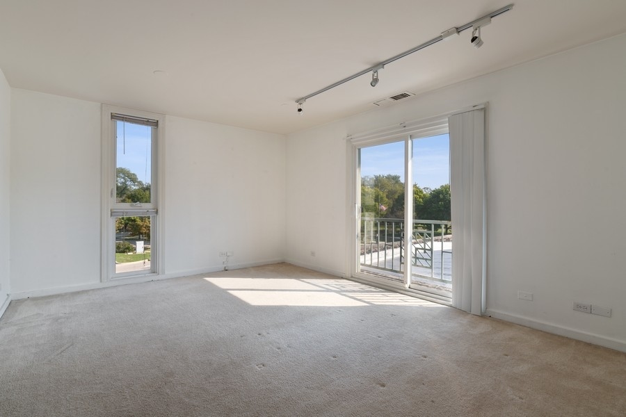 2114 Central Street, Unit A Evanston, IL 60201 - Photo 8 of 10 a view of an empty room with a window