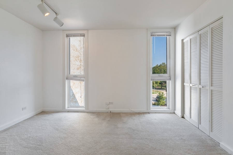 2114 Central Street, Unit A Evanston, IL 60201 - Photo 9 of 10 an empty room with windows and closet