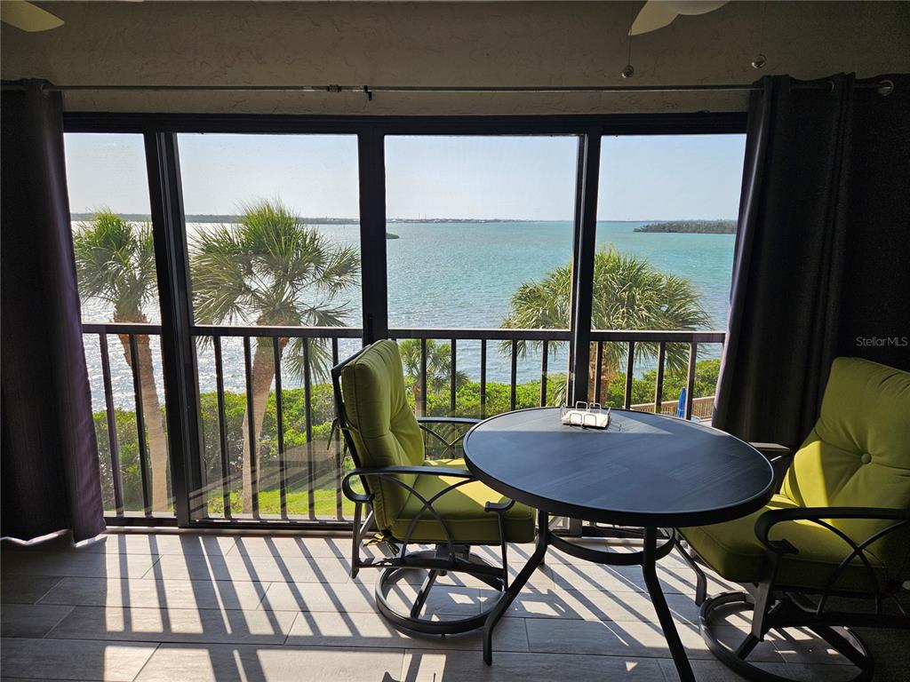 1501 Beach Road, Unit 403 Englewood, FL 34223 - Photo 2 of 8 a view of a balcony with chairs and a table