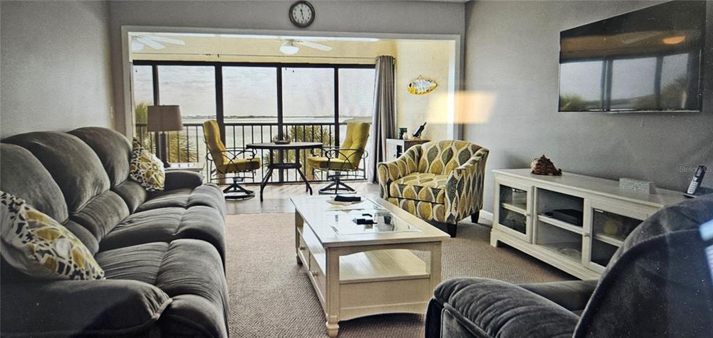 1501 Beach Road, Unit 403 Englewood, FL 34223 - Photo 5 of 8 a living room with furniture fireplace and a large window