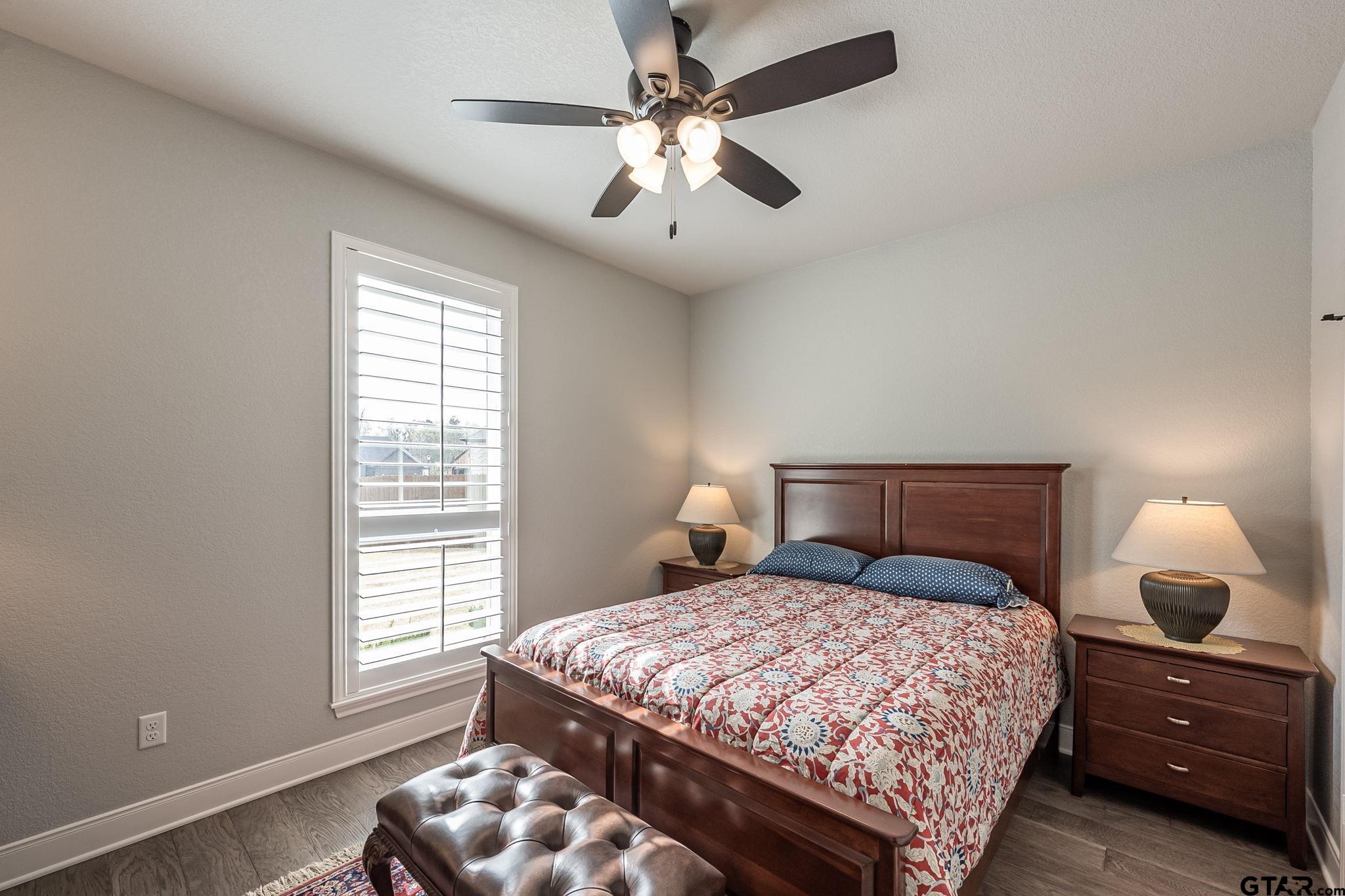 11858 Gillian Court Tyler, TX 75703 - Photo 14 of 24 a bedroom with a large bed and a window
