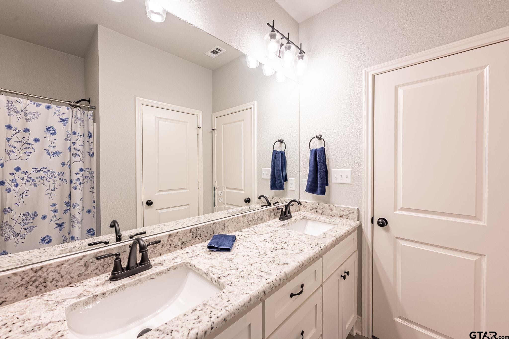 11858 Gillian Court Tyler, TX 75703 - Photo 15 of 24 a bathroom with a granite countertop sink and a mirror
