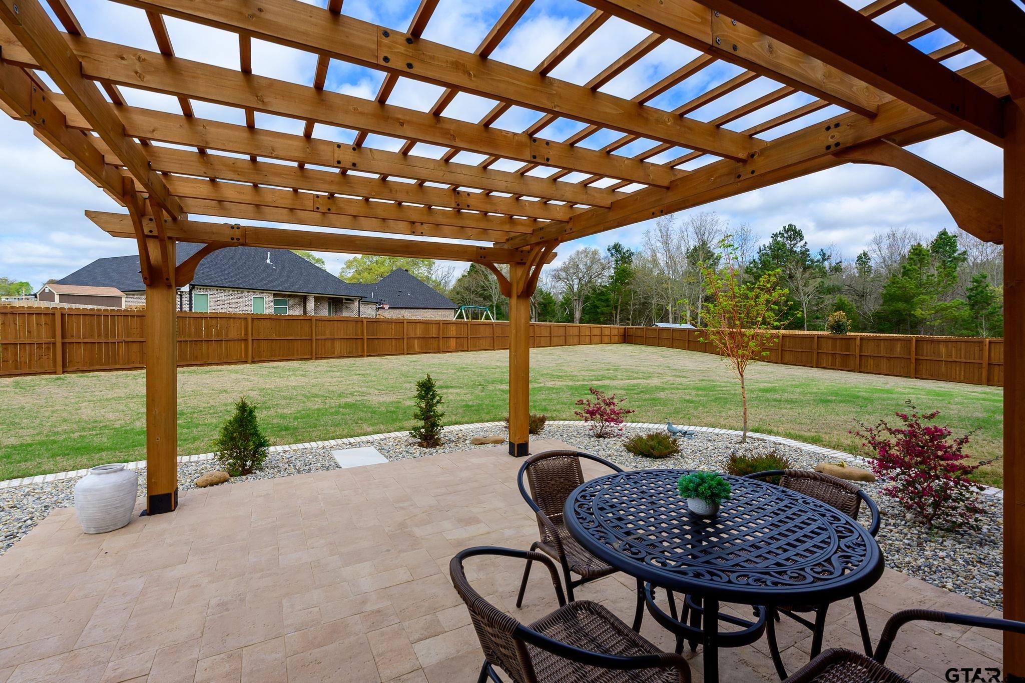 11858 Gillian Court Tyler, TX 75703 - Photo 18 of 24 a patio with yard table and chairs