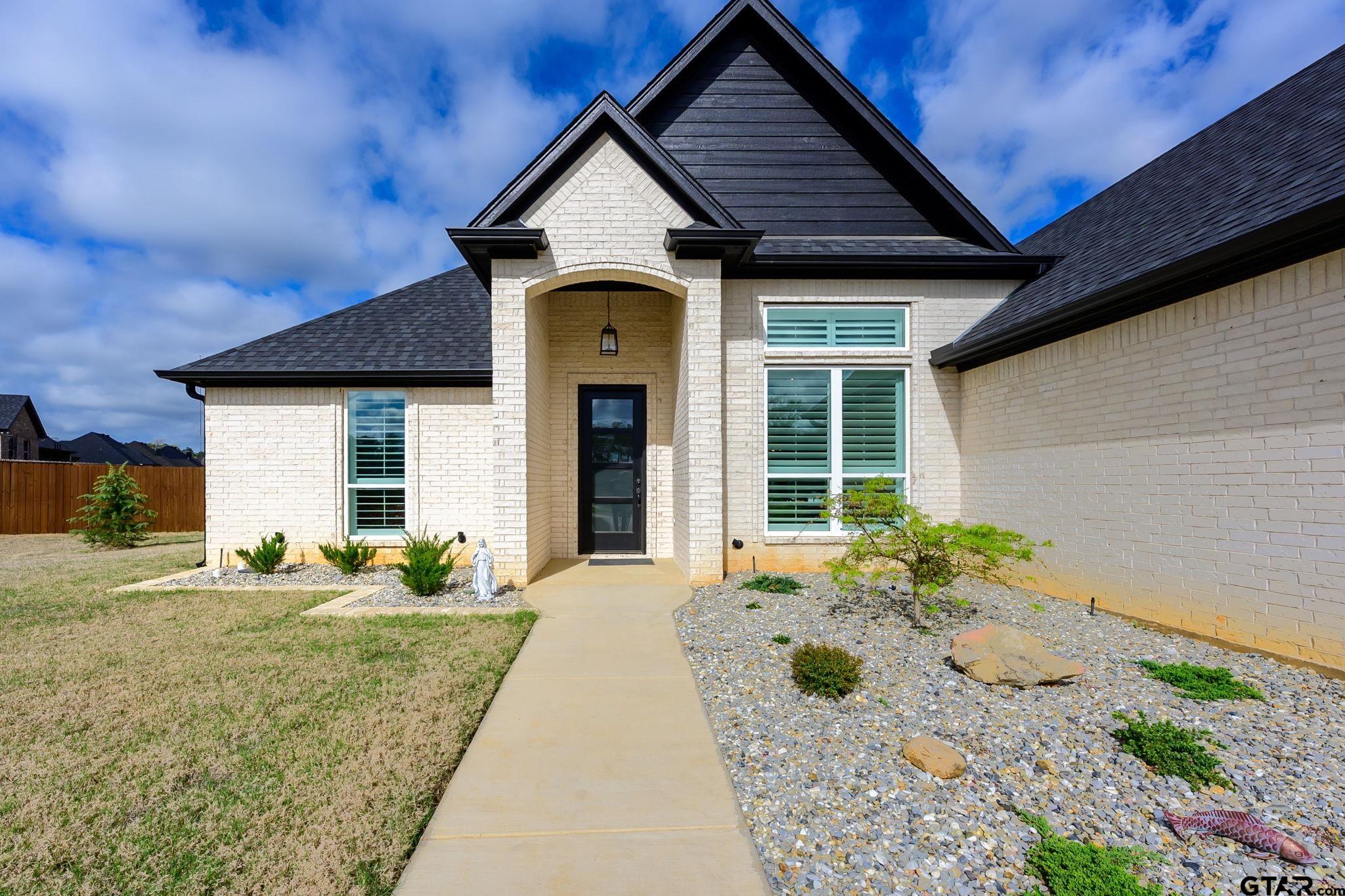 11858 Gillian Court Tyler, TX 75703 - Photo 19 of 24 a front view of a house with garden