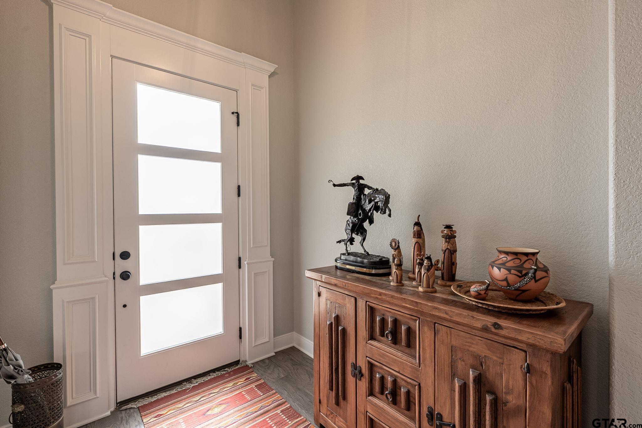 11858 Gillian Court Tyler, TX 75703 - Photo 2 of 24 a view of a room with baby crib and wooden floor