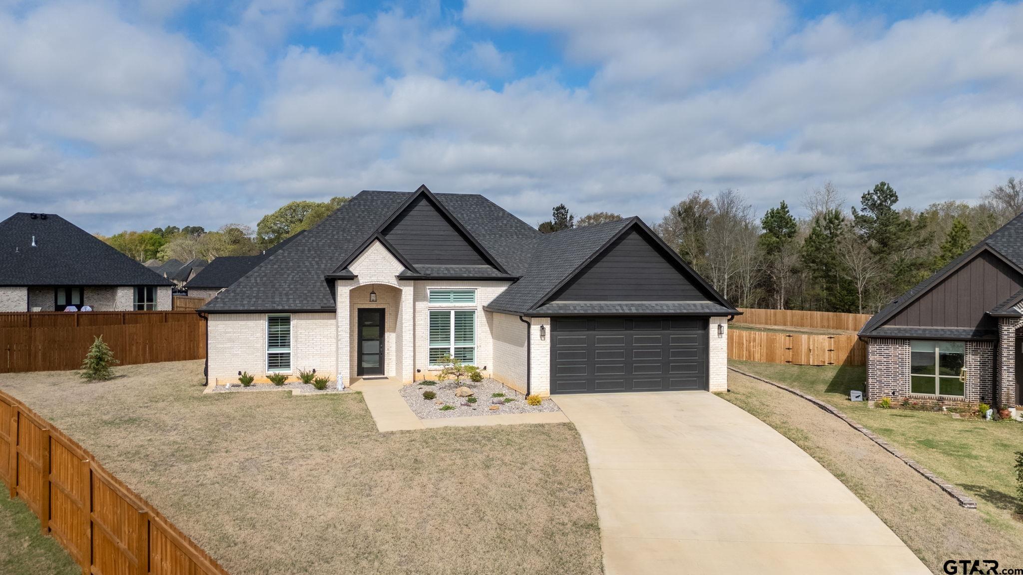11858 Gillian Court Tyler, TX 75703 - Photo 21 of 24 a front view of a house with a yard and garage