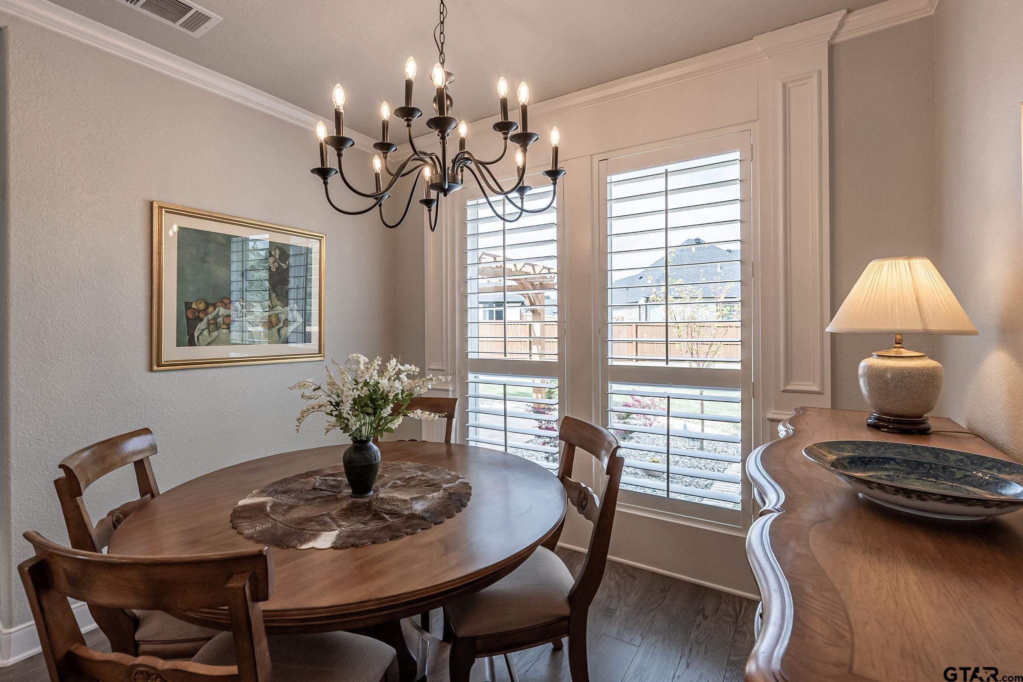 11858 Gillian Court Tyler, TX 75703 - Photo 5 of 24 a view of a dining room with furniture wooden floor and chandelier