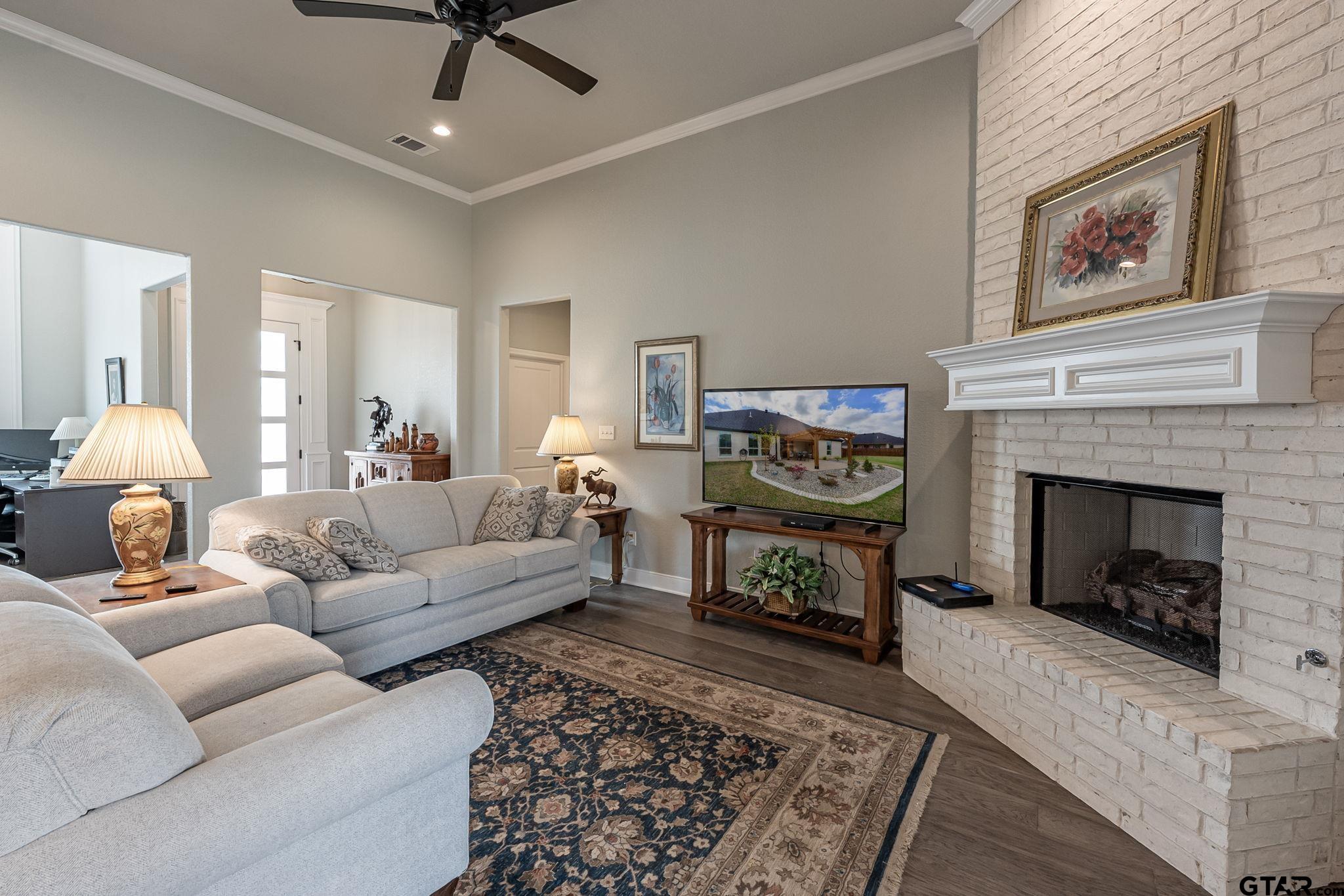 11858 Gillian Court Tyler, TX 75703 - Photo 7 of 24 a living room with furniture and a fireplace