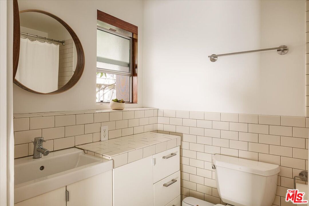3733 Rolle Street Los Angeles, CA 90031 - Photo 20 of 36 a bathroom with a sink a toilet and a mirror