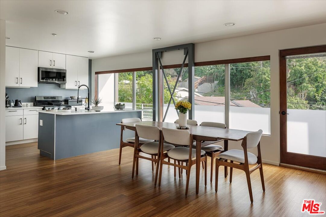 3733 Rolle Street Los Angeles, CA 90031 - Photo 3 of 36 a dining room with wooden floor a chandelier a glass table and chairs