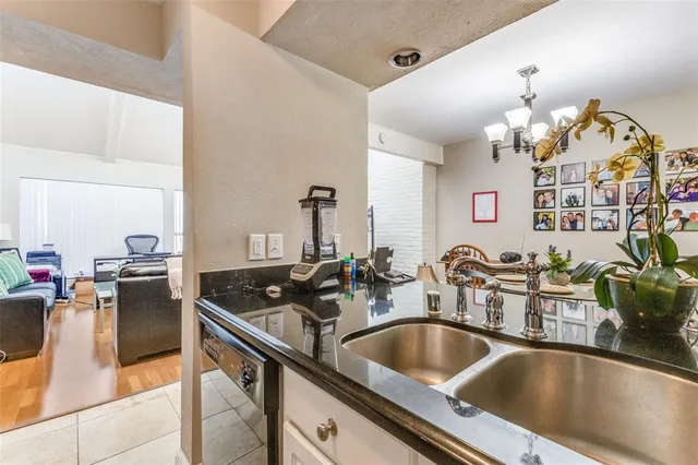 a kitchen with a sink appliances and cabinets