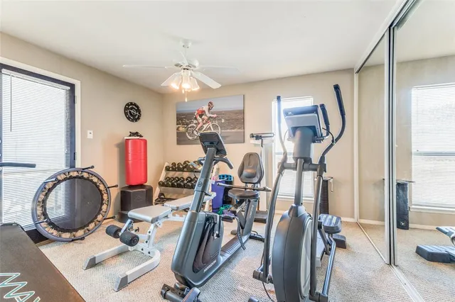 a room with gym equipment and mirror